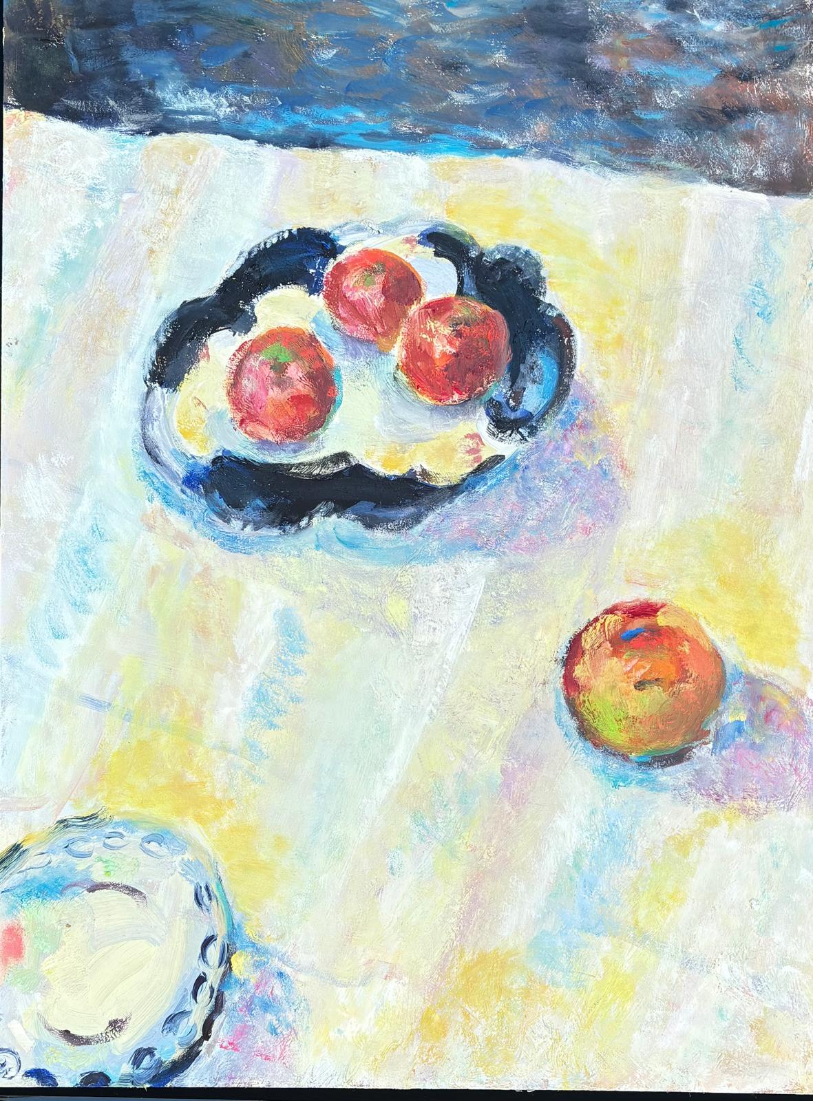 Oil painting of red apples on a dark patterned plate and scattered on a pale yellow tablecloth, with a blue patterned bowl in the corner.