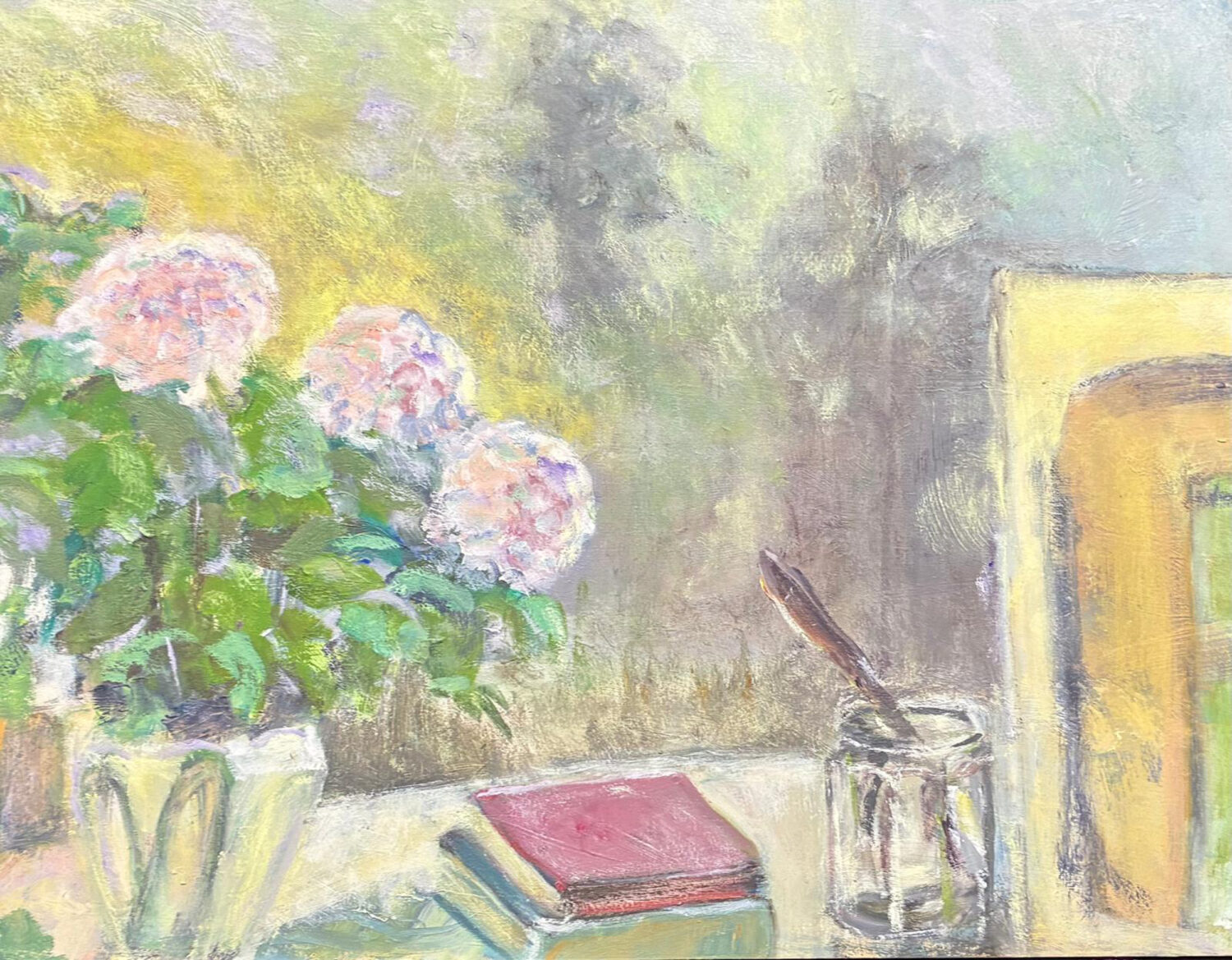 Oil painting of pink and white flowers in a jug, with a red book and a paintbrush in a glass jar on a studio table, and a yellow doorway in the background.