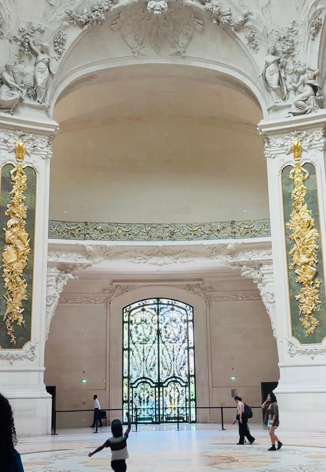 Inside the Grand Palais: the gilded atrium with the wrought-iron gates