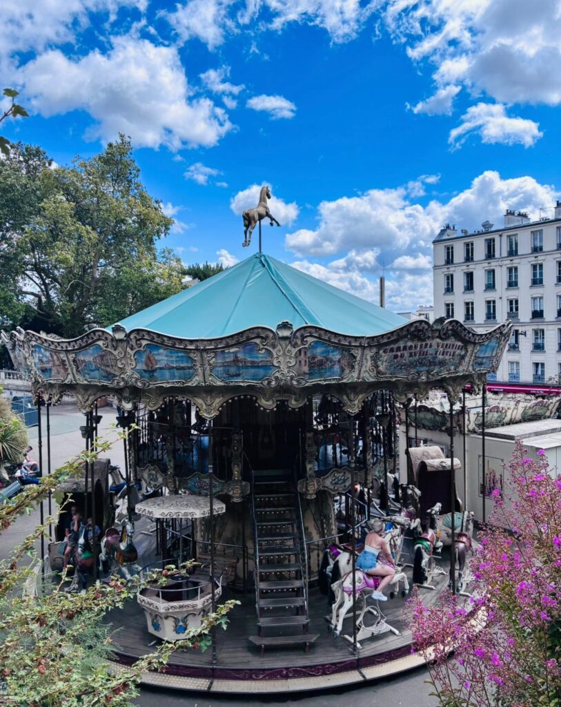 The Carrousel Vénitien du XVIIIème Siècle in Montmartre, with its teal roof and horse weathervane.